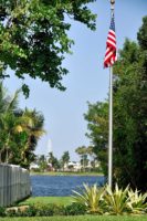 The flag pole at the Litoral Preserve, looking east with the lake and lighthouse in the background.